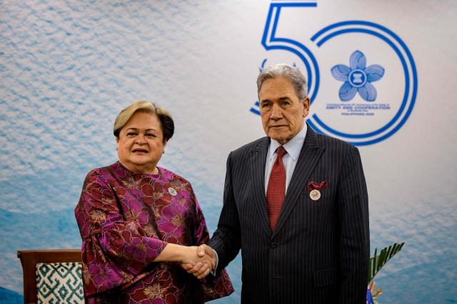 Philippines Foreign Secretary Theresa Lazaro (L) and New Zealand Foreign Minister Winston Peters shake hands during a bilateral meeting on the sidelines of the Association of Southeast Asian Nations (ASEAN) Foreign Ministers' Meeting in Pasay, Metro Manila on July 21, 2026. (Photo by Ezra Acayan / POOL / AFP)