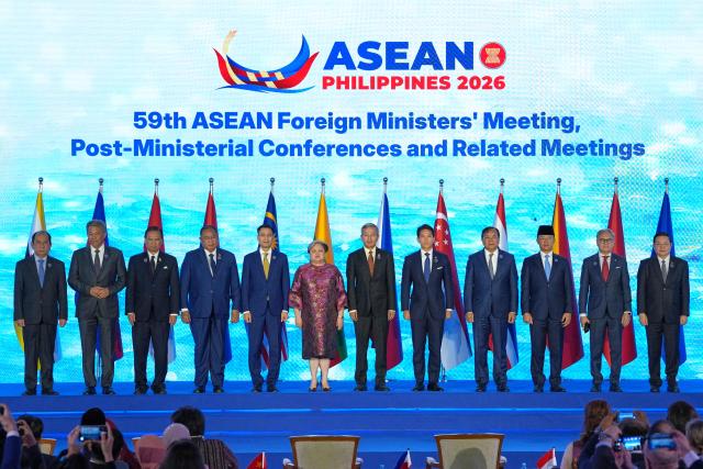 (L-R) Malaysia's Foreign Minister Mohamad Hasan, Thailand's Foreign Minister Sihasak Phuangketkeow, East Timor's Foreign Minister Bendito dos Santos Freitas, Vietnam's Deputy Minister of Foreign Affairs Dang Hoang Giang, Philippine Foreign Secretary Theresa Lazaro, Singapore's Foreign Minister Vivian Balakrishnan, Brunei's Foreign Minister Abdul Mateen Bolkiah, Cambodia's Foreign Minister Prak Sokhonn, Indonesia's Foreign Minister Sugiono, Laos Foreign Minister Thongsavanh Phomvihane and ASEAN Secretary-General Kao Kim Hourn pose during the opening ceremony of the Association of Southeast Asian Nations (ASEAN) Foreign Ministers' Meeting in Pasay, Metro Manila on July 21, 2026. (Photo by Aaron Favila / POOL / AFP)