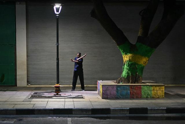 A man exercises along a road in Chennai on July 21, 2026. (Photo by R.Satish BABU / AFP)