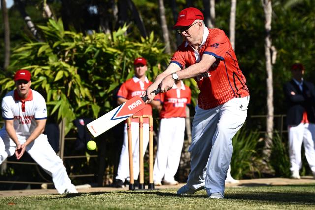 Australian Prime Minister Anthony Albanese plays a shot as he takes part in a charity backyard cricket match at Kirribilli House in Sydney on July 21, 2026. (Photo by DAN HIMBRECHTS / POOL / AFP)