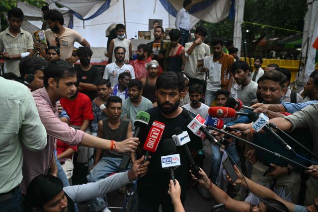 Cockroach Janta Party (CJP) founder Abhijeet Dipke speaks to the media during a protest demanding the resignation of India's Education Minister Dharmendra Pradhan over alleged NEET exam irregularities, in New Delhi on July 21, 2026. India's "Cockroach" party movement vowed on July 21 to press ahead with their campaign until Education Minister Dharmendra Pradhan resigns. (Photo by Arun SANKAR / AFP)
