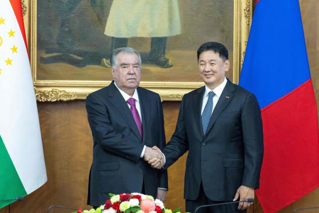 Mongolia's President Ukhnaagiin Khurelsukh (R) and Tajikistan's President Emomali Rahmon shake hands during a meeting in Ulaanbaatar on July 21, 2026. (Photo by Byambasuren BYAMBA-OCHIR / AFP)