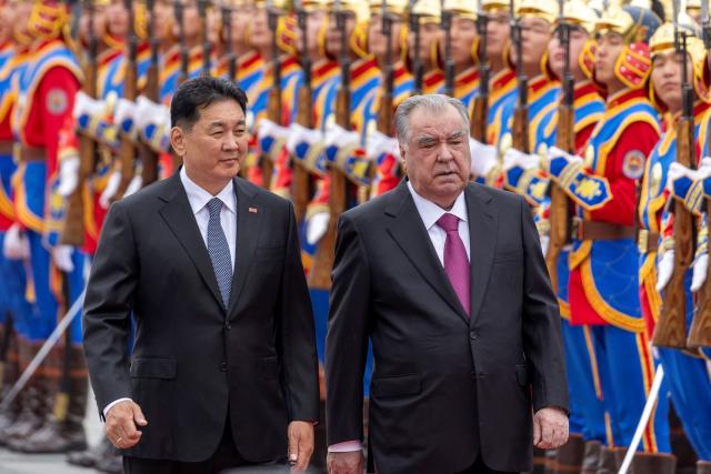 Mongolia's President Ukhnaagiin Khurelsukh (L) and Tajikistan's President Emomali Rahmon review honour guards during a welcome ceremony in Ulaanbaatar on July 21, 2026. (Photo by Byambasuren BYAMBA-OCHIR / AFP)