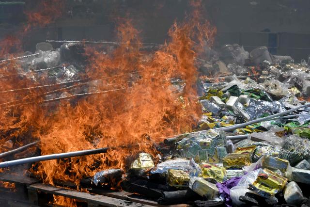 A general views of burn seized drugs during a destruction ceremony to mark the UN's "International Day against Drug Abuse and Illicit Trafficking" in Kandal province on July 21, 2026. (Photo by TANG CHHIN Sothy / AFP)
