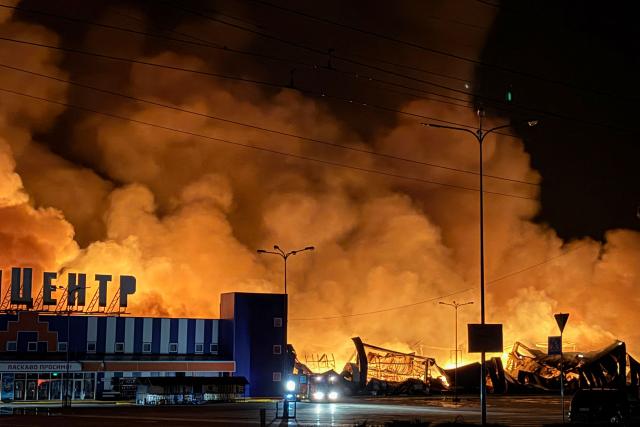 Ukraine's firefighters work to extinguish a fire at the site of a drone strike on a shopping centre in Sumy late at night on July 20, 2026, amid the Russian invasion of Ukraine. (Photo by Serhii Shapovalov (STR) / AFP)