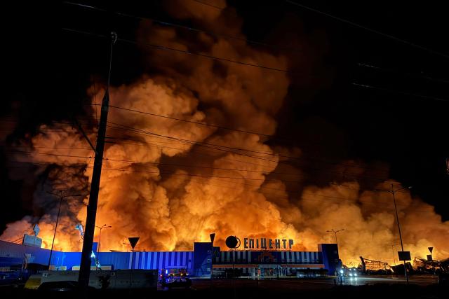 Ukraine's firefighters work to extinguish a fire at the site of a drone strike on a shopping centre in Sumy late at night on July 20, 2026, amid the Russian invasion of Ukraine. (Photo by Serhii Shapovalov (STR) / AFP)