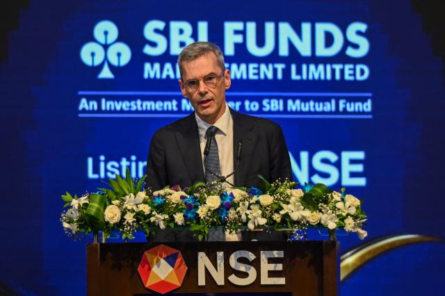 Nicolas Calcoen, Deputy Chief Executive Officer of Amundi, speaks during the listing ceremony of SBI funds management limited at the National Stock Exchange (NSE) in Mumbai on July 21, 2026. (Photo by Punit PARANJPE / AFP)