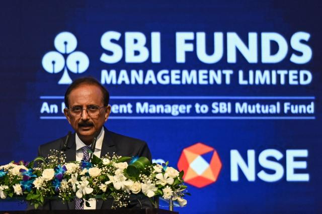 Chairman of State Bank of India, Challa Sreenivasulu Setty speaks during the listing ceremony of SBI funds management limited at the National Stock Exchange (NSE) in Mumbai on July 21, 2026. (Photo by Punit PARANJPE / AFP)