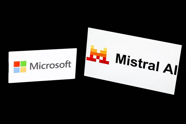 This illustration photograph shows the logos of Microsoft (L) and Mistral AI displayed on screens, in Paris on July 21, 2026. Microsoft and Mistral said on July 21, 2026 they had signed a "multibillion dollar" deal for the US tech giant to use the French AI developer's computing infrastructure in Europe. The agreement would grant Microsoft access to "Europe-based GPU (graphics processing unit) infrastructure to increase capacity for AI development and to support the delivery of Microsoft's cloud and AI services," the companies said in a joint statement. (Photo by Xavier GALIANA / AFP)