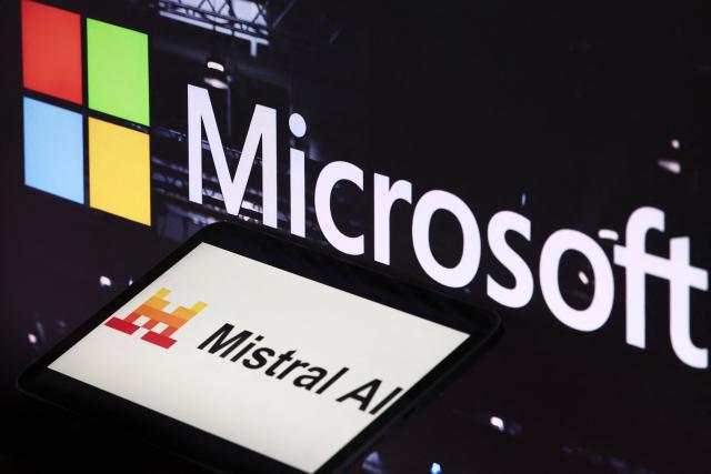 This illustration photograph shows the logos of Microsoft (top) and Mistral AI displayed on screens, in Paris on July 21, 2026. Microsoft and Mistral said on July 21, 2026 they had signed a "multibillion dollar" deal for the US tech giant to use the French AI developer's computing infrastructure in Europe. The agreement would grant Microsoft access to "Europe-based GPU (graphics processing unit) infrastructure to increase capacity for AI development and to support the delivery of Microsoft's cloud and AI services," the companies said in a joint statement. (Photo by Xavier GALIANA / AFP)