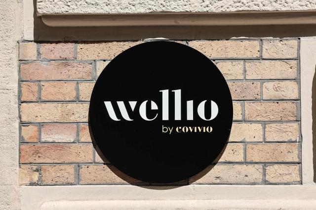 This photograph shows the logo of Wellio, a flexible office and coworking brand operated by French real estate company Covivo, in Paris on July 21, 2026.  (Photo by Xavier GALIANA / AFP)