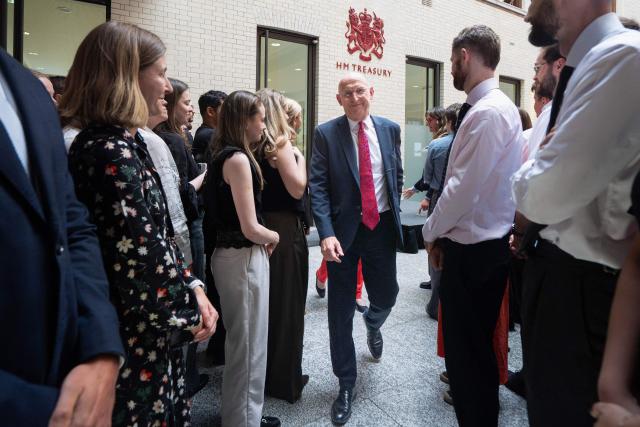 Britain's newly appointed Chancellor of the Exchequer John Healey (C) visits the HM Treasury as he gives his first all-staff address after becoming the new chancellor, in central London on July 21, 2026. (Photo by Stefan Rousseau / POOL / AFP)