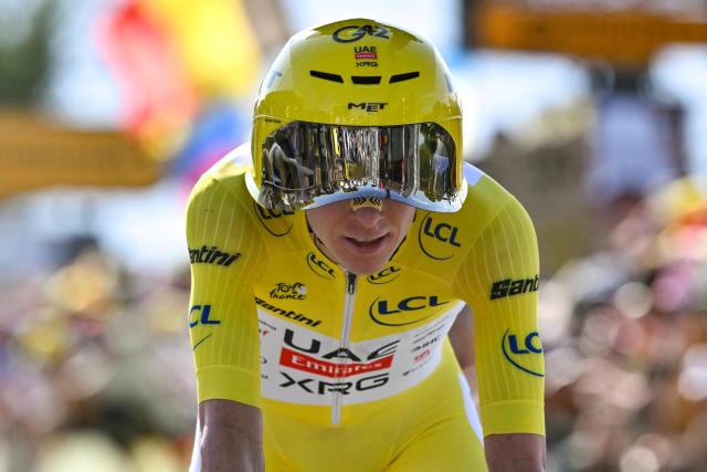 UAE Team Emirates - XRG's Slovenian rider Tadej Pogacar wearing the overall leader's yellow jersey cycles past the Lac Leman during the 16th stage of the 113th edition of the Tour de France cycling race, 26,1 km time trial between Évian-les-Bains and Thonon-les-Bains in the French Alps, on July 21, 2026. (Photo by Jeff PACHOUD / AFP)