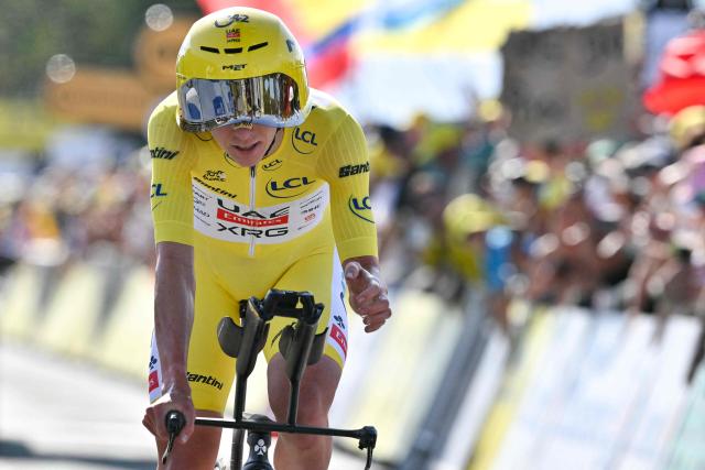UAE Team Emirates - XRG's Slovenian rider Tadej Pogacar wearing the overall leader's yellow jersey cycles past the Lac Leman during the 16th stage of the 113th edition of the Tour de France cycling race, 26,1 km time trial between Évian-les-Bains and Thonon-les-Bains in the French Alps, on July 21, 2026. (Photo by Jeff PACHOUD / AFP)