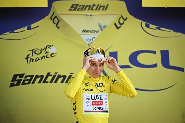UAE Team Emirates - XRG's Slovenian rider Tadej Pogacar  celebrates on the podium with the overall leader's yellow jersey after the 16th stage of the 113th edition of the Tour de France cycling race, 26 km between Évian-les-Bains and Thonon-les-Bains in the French Alps, on July 21, 2026. (Photo by Loic VENANCE / AFP)