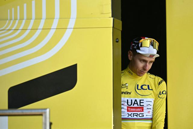 UAE Team Emirates - XRG's Slovenian rider Tadej Pogacar  celebrates on the podium with the overall leader's yellow jersey after the 16th stage of the 113th edition of the Tour de France cycling race, 26 km between Évian-les-Bains and Thonon-les-Bains in the French Alps, on July 21, 2026. (Photo by Loic VENANCE / AFP)