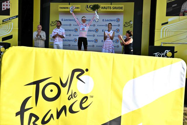 UAE Team Emirates - XRG's Slovenian rider Tadej Pogacar celebrates on the podium with the best climber's polka dot (dotted) jersey after the 16th stage of the 113th edition of the Tour de France cycling race, 26 km between Évian-les-Bains and Thonon-les-Bains in the French Alps, on July 21, 2026. (Photo by Jeff PACHOUD / AFP)