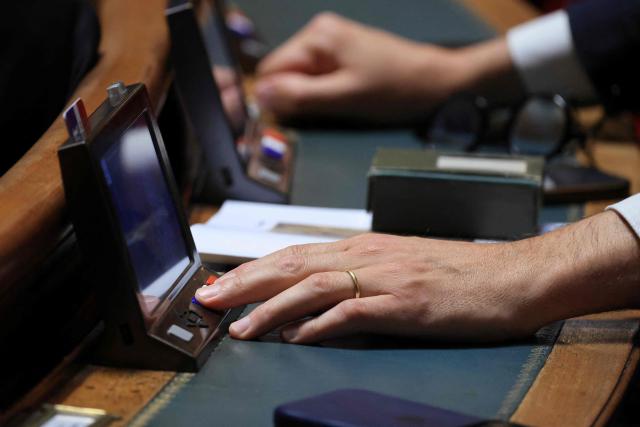 A senator votes after a session to examine the final draft of emergency bill for agricultural protection and sovereignty, at the Senat in Paris on July 21, 2026. (Photo by Ludovic MARIN / AFP)