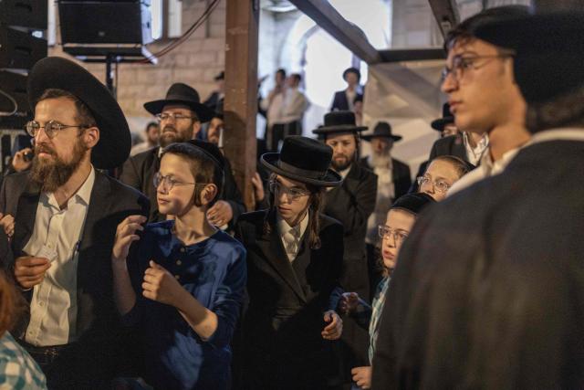 Ultra-Orthodox Jewish men pray along a street in the Orthodox Jewish neighbourhood of Ezrat Torah in Jerusalem on July 21, 2026. (Photo by ilia YEFIMOVICH / AFP)