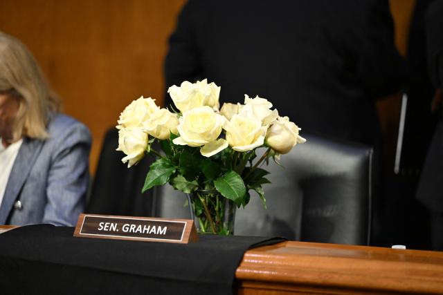 Flowers are seen at the seat of late Senator Lindsey Graham before US Defense Secretary Pete Hegseth, Chairman of the Joint Chiefs of Staff Gen. Dan Caine and Secretary of Agriculture Brooke Rollins are to testify during a Senate Committee on Appropriations hearing on Capitol Hill in Washington, DC, on July 21, 2026. US lawmakers are conducting a hearing to examine a review of US President Donald Trump's supplemental funding request of June 24, 2026. (Photo by Alex WROBLEWSKI / AFP)