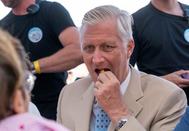 King Philippe of Belgium eats as he attends the "Everyone to the Table" event to celebrate Belgium's National Day at Place du Jeu de Balle in Brussels on July 21, 2026. (Photo by JONAS ROOSENS / Belga / AFP) / Belgium OUT