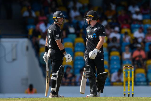 Batsmen Will Young (L) and Nick Kelly of New Zealand chat after reaching a 50-run  partnership during the fifth and final one day international (ODI) cricket match between West Indies and New Zealand at Kensington Oval in Bridgetown, Barbados on July 21, 2026. (Photo by Randy Brooks / AFP)