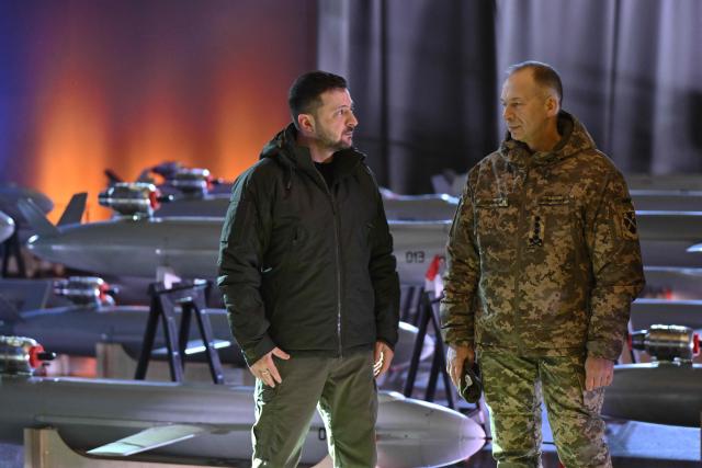 (FILES) Ukrainian President Volodymyr Zelensky (L) and Commander-in-Chief of the Armed Forces of Ukraine Oleksandr Syrsky (R) speak next to the first batch of Ukrainian made drone missiles "Peklo" (Hell) delivered to the Defence Forces of Ukraine in Kyiv on December 6, 2024, amid the Russian invasion of Ukraine. Ukrainian President Volodymyr Zelensky said on July 21, 2026 that he was dismissing Oleksandr Syrsky, commander-in-chief of Ukraine's army, and appointing joint forces commander Mykhailo Drapaty in his place. (Photo by Genya SAVILOV / AFP)