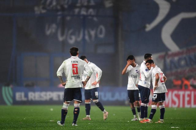Nacional players react after losing the first leg of the Copa Sudamericana knockout round play-off football match between Uruguay's Nacional and Argentina's Tigre at the Gran Parque Central satdium in Montevideo, on July 21, 2026. (Photo by Dante FERNANDEZ / AFP)