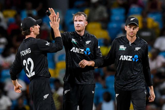 Jayden Lennox (C) and Mitchell Santner (R) of New Zealand celebrates the dismissal of Keacy Carty of West Indies during the fifth and final one day international (ODI) cricket match between West Indies and New Zealand at Kensington Oval in Bridgetown, Barbados on July 21, 2026. (Photo by Randy Brooks / AFP)