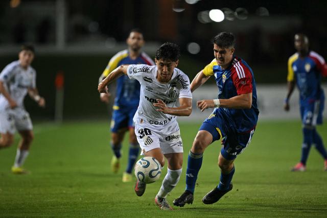 Santos' Bolivian midfielder #30 Miguel Terceros (L) and Universidad Central's defender #06 Gonzalo Mottes fight for the ball during the first leg of the Copa Sudamericana knockout round play-off football match between Venezuela's Universidad Central and Brazil's Santos, at the Misael Delgado stadium in Valencia, Venezuela, on July 21, 2026. (Photo by Federico PARRA / AFP)