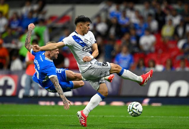 Cruz Azul's Argentine forward #29 Rodolfo Rotondi (L) and Puebla's Argentine defender #05 Facundo Almada fight for the ball during the Liga MX Apertura football match between Cruz Azul and Puebla at Banorte stadium in Mexico City on July 21, 2026. (Photo by Alfredo ESTRELLA / AFP)