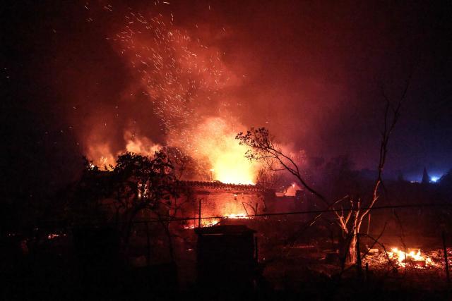 A house is consumed by fire in Cotignac, southeastern France, on July 22, 2026. A wildfire advancing at surprising speed in southern France forced the evacuation of nearly 400 people from several villages on July 21, 2026, the top official for the Var region said. The evacuations took place around the villages of Cotignac, Montfort-sur-Argens and Correns, and some 1,700 hectares (4,200 acres) have already burned, the official added. (Photo by Thibaud MORITZ / AFP)