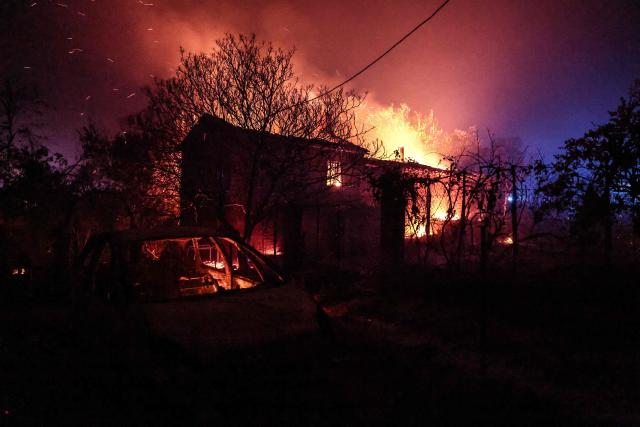 A house is consumed by fire in Cotignac, southeastern France, on July 22, 2026. A wildfire advancing at surprising speed in southern France forced the evacuation of nearly 400 people from several villages on July 21, 2026, the top official for the Var region said. The evacuations took place around the villages of Cotignac, Montfort-sur-Argens and Correns, and some 1,700 hectares (4,200 acres) have already burned, the official added. (Photo by Thibaud MORITZ / AFP)