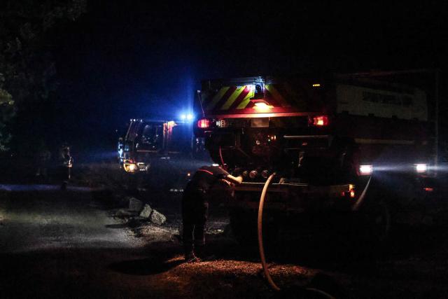 Firefighters battle a wildfire near Cotignac, southeastern France, on July 22, 2026. A wildfire advancing at surprising speed in southern France forced the evacuation of nearly 400 people from several villages on July 21, 2026, the top official for the Var region said. The evacuations took place around the villages of Cotignac, Montfort-sur-Argens and Correns, and some 1,700 hectares (4,200 acres) have already burned, the official added. (Photo by Thibaud MORITZ / AFP)