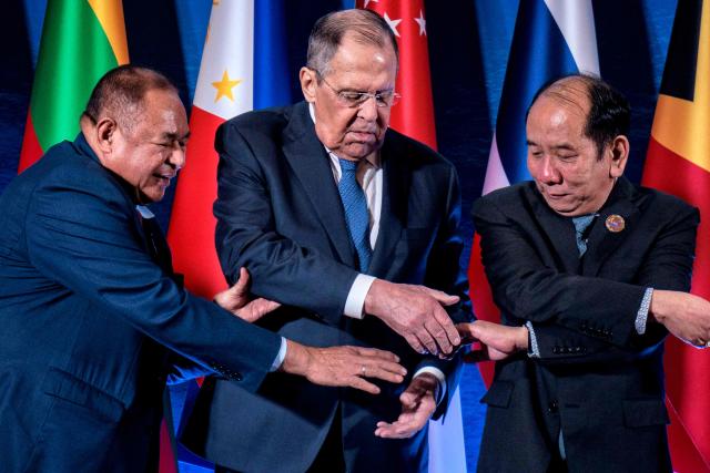 (From L-R) East Timor's Foreign Minister Bendito dos Santos Freitas, Russia's Foreign Minister Sergey Lavrov, and Myanmar Permanent Secretary Hau Khan Sum link hands as they pose for a group photo during the ASEAN Post-Ministerial Conference with Russia on the sidelines of the Association of Southeast Asian Nations (ASEAN) Foreign Ministers' Meeting in Pasay, Metro Manila on July 22, 2026. (Photo by Ezra Acayan / POOL / AFP)