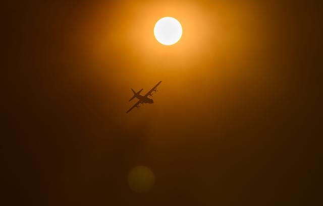 A CalFire plane flies during Little Fire in Pleasanton, California on July 21, 2026. (Photo by Josh Edelson / AFP)