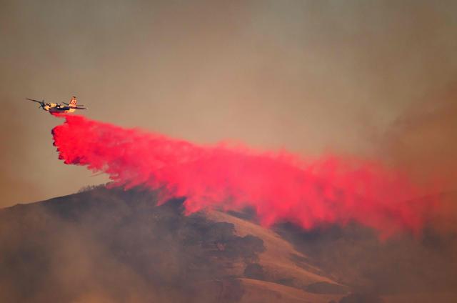 A CalFire aircraft drops fire retardant on Little Fire in Pleasanton, California on July 21, 2026. (Photo by Josh Edelson / AFP)
