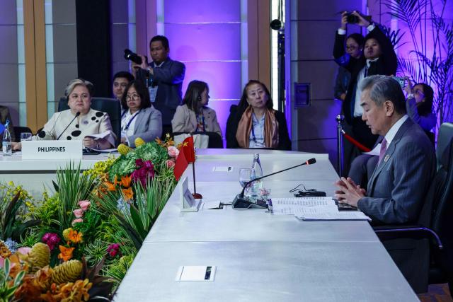 Philippine Foreign Secretary Theresa Lazaro (2nd L) listens to Chinese Foreign Minister Wang Yi at the opening of the ASEAN Post-Ministerial Conference with China during the Association of Southeast Asian Nations (ASEAN) Foreign Ministers' Meeting in Pasay, Metro Manila on July 22, 2026. (Photo by Rolex DELA PENA / POOL / AFP)
