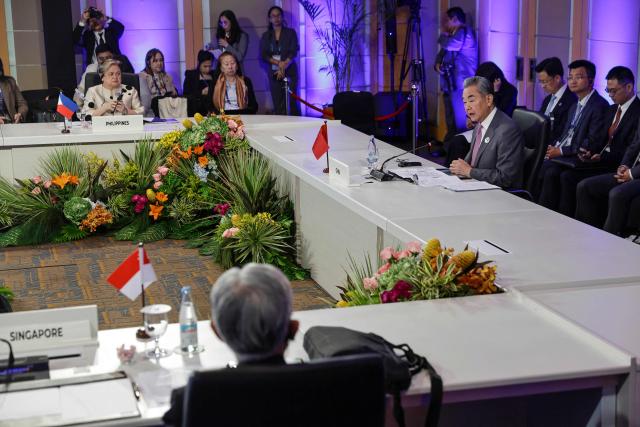 Philippine Foreign Secretary Theresa Lazaro (2nd L) listens to Chinese Foreign Minister Wang Yi at the opening of the ASEAN Post-Ministerial Conference with China during the Association of Southeast Asian Nations (ASEAN) Foreign Ministers' Meeting in Pasay, Metro Manila on July 22, 2026. (Photo by Rolex DELA PENA / POOL / AFP)
