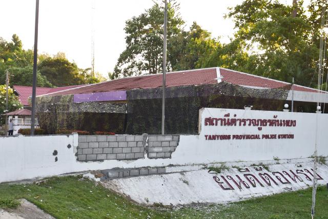 The old Khao Tanyong police station, seen partially covered in camouflage netting, is pictured in Thailand's southern province of Narathiwat on July 22, 2026, after an explosive device planted on a car was detonated overnight. (Photo by Madaree TOHLALA / AFP)