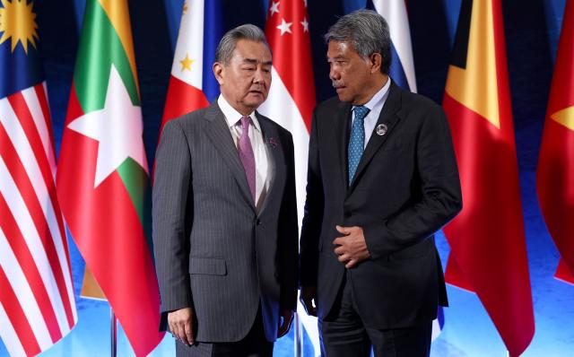 Malaysia's Foreign Minister Mohamad Hasan (R) talks with Chinese Foreign Minster Wang Yi during the ASEAN Post Ministerial Conference with China on the sidelines of the Association of Southeast Asian Nations (ASEAN) Foreign Ministers' Meeting in Pasay, Metro Manila on July 22, 2026. (Photo by ELOISA LOPEZ / POOL / AFP)