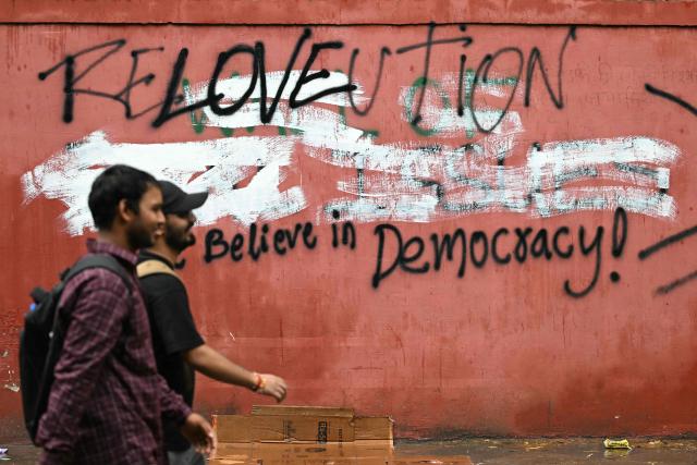 Cockroach Janta Party (CJP) supporters arrive at the protest site to demand the resignation of India's Education Minister Dharmendra Pradhan over alleged NEET exam irregularities, in New Delhi on July 22, 2026. (Photo by Sajjad HUSSAIN / AFP)