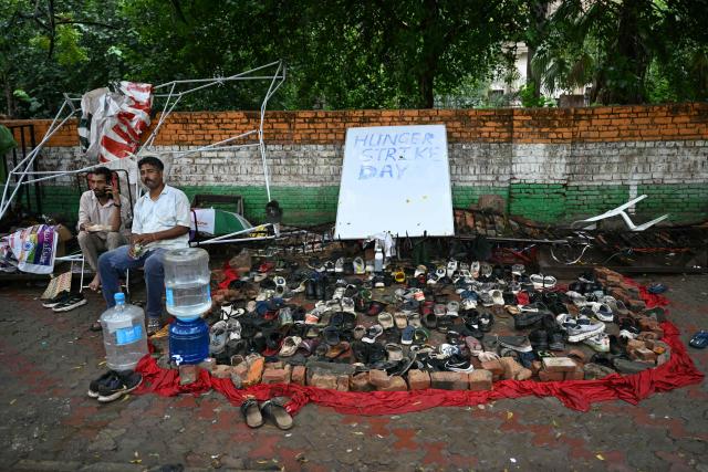 Shoes left behind by Cockroach Janta Party (CJP) supporters are kept at the protest site  at Jantar Mantar in New Delhi on July 22, 2026 during the ongoing protest to demand the resignation of India's Education Minister Dharmendra Pradhan over alleged NEET exam irregularities. (Photo by Sajjad HUSSAIN / AFP)