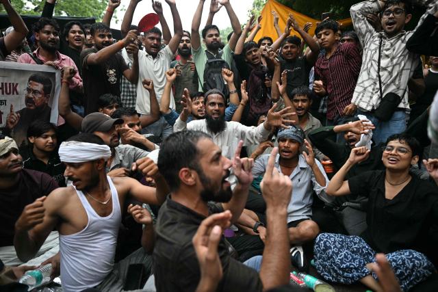 Cockroach Janta Party (CJP) supporters shout slogans at Jantar Mantar in New Delhi on July 22, 2026 during the ongoing protest to demand the resignation of India's Education Minister Dharmendra Pradhan over alleged NEET exam irregularities. (Photo by Sajjad HUSSAIN / AFP)