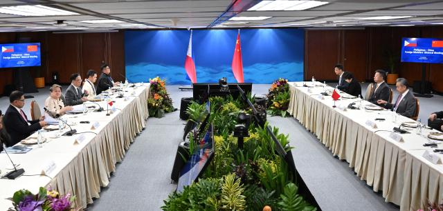 China's Foreign Minister Wang Yi (3rd R) hold bilateral talks with Philippine Foreign Secretary Theresa Lazaro (4th R) on the sidelines of the Association of Southeast Asian Nations (ASEAN) Foreign Ministers' Meeting in Pasay, Metro Manila on July 22, 2026. (Photo by Ted ALJIBE / POOL / AFP)