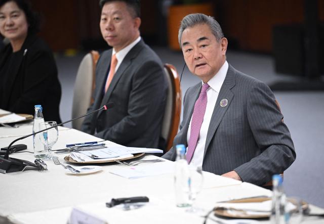 China's Foreign Minister Wang Yi (3rd R) hold bilateral talks with Philippine Foreign Secretary Theresa Lazaro (not picture) on the sidelines of the Association of Southeast Asian Nations (ASEAN) Foreign Ministers' Meeting in Pasay, Metro Manila on July 22, 2026. (Photo by Ted ALJIBE / POOL / AFP)