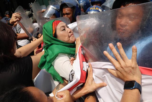 Demonstrators push back against police as they protest US Secretary of State Marco Rubio's visit to the Philippines to attend the Association of Southeast Asian Nations (ASEAN) Foreign Ministers' Meeting outside the meeting venue in Pasay, Metro Manila on July 22, 2026. (Photo by Bullit MARQUEZ / AFP)