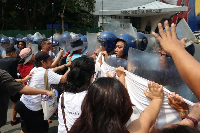 Demonstrators push back against police as they protest US Secretary of State Marco Rubio's visit to the Philippines to attend the Association of Southeast Asian Nations (ASEAN) Foreign Ministers' Meeting outside the meeting venue in Pasay, Metro Manila on July 22, 2026. (Photo by Bullit MARQUEZ / AFP)
