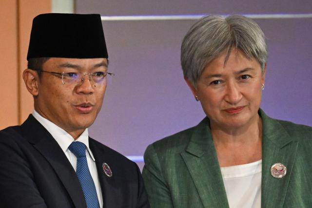 Indonesia's Minister of Foreign Affairs Sugiono (L) speaks to Australia's Foreign Minister Penny Wong during the Association of Southeast Asian Nations (ASEAN) Post Ministerial conference with Australia on the sidelines of the 59th Association of Southeast Asian Nations (ASEAN) Foreign Ministers' Meeting in Pasay, metro Manila on July 22, 2026. (Photo by Ted ALJIBE / POOL / AFP)