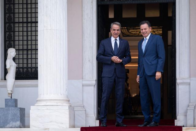 Greece's Prime Minister Kyriakos Mitsotakis (L) welcomes Portugal's Prime Minister Luis Montenegro upon his arrival ahead of their meeting, in Athens on July 22, 2026. (Photo by Aris MESSINIS / AFP)